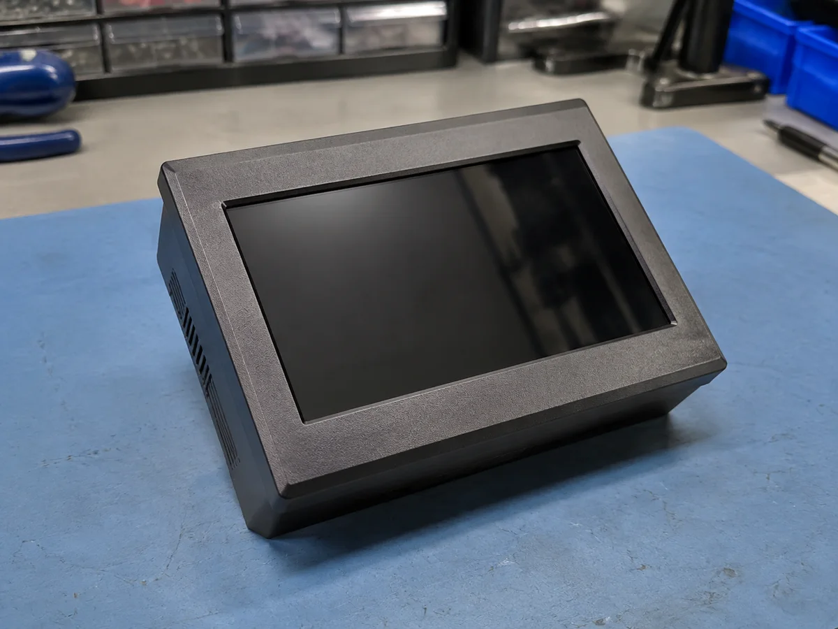 Illustrated application: Glass front panel fitted within an industrial electronics housing